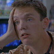 a picture of stu macher from scream. he is leaning his head on his hand and faking being deep in thought